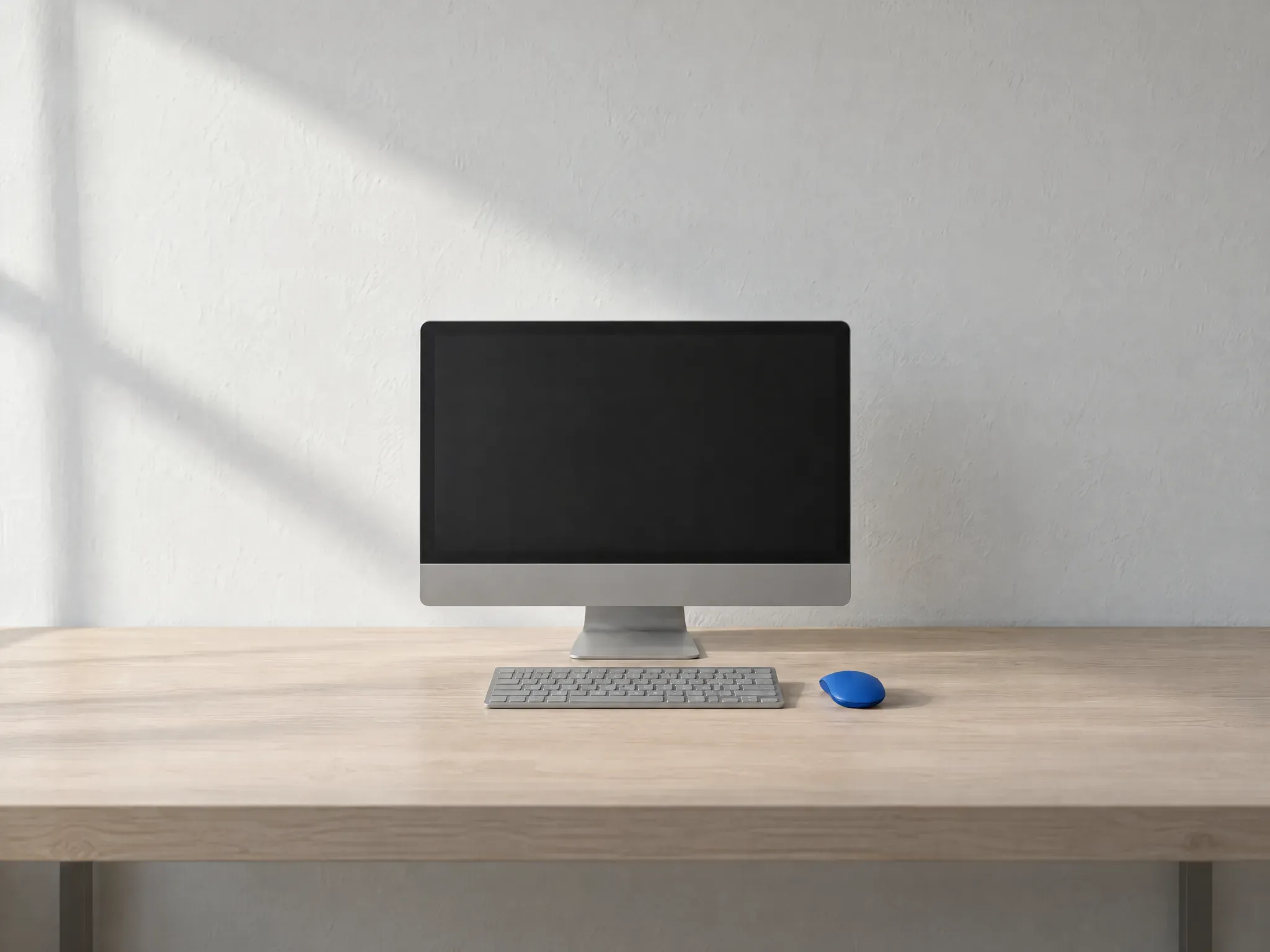 A new office desk with a grey computer, a grey keyboard and one blue mouse